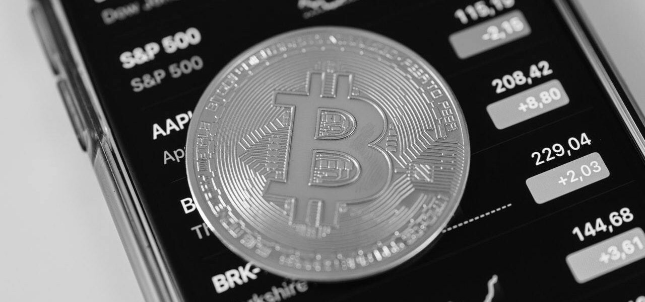 Crypto coin on smartphone in black and white - Paul Rothschild